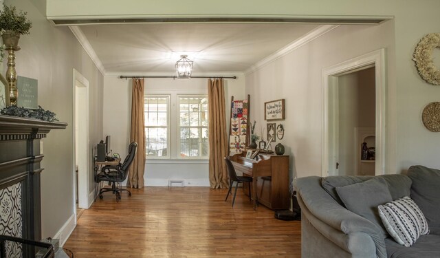 living room with dark hardwood / wood-style floors, a notable chandelier, and ornamental molding