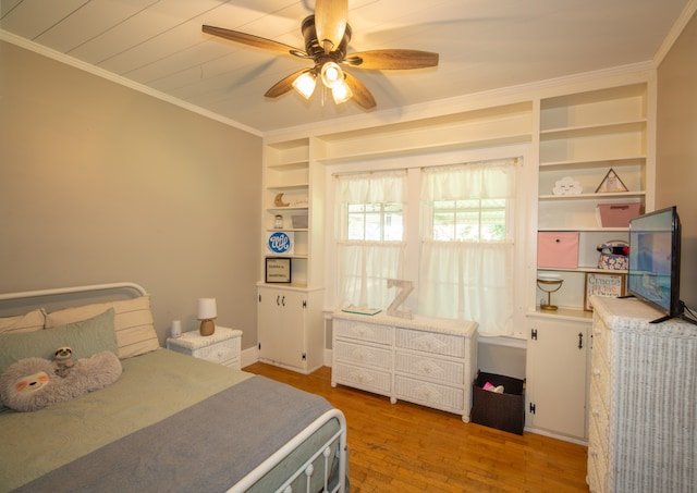 bedroom with hardwood / wood-style flooring, ornamental molding, and ceiling fan