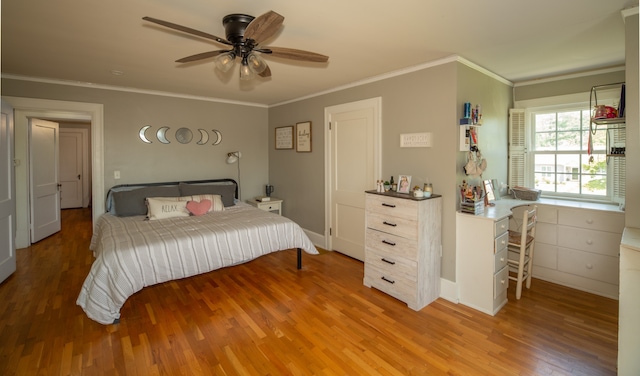 bedroom with ceiling fan, hardwood / wood-style floors, and ornamental molding