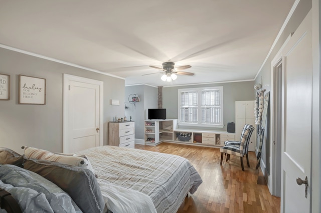 bedroom with crown molding, ceiling fan, and light hardwood / wood-style flooring