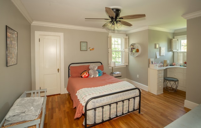 bedroom with crown molding, wood-type flooring, and ceiling fan