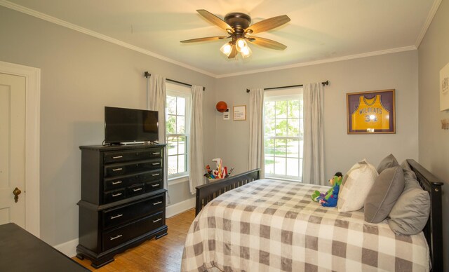 bedroom with ceiling fan, ornamental molding, and wood-type flooring