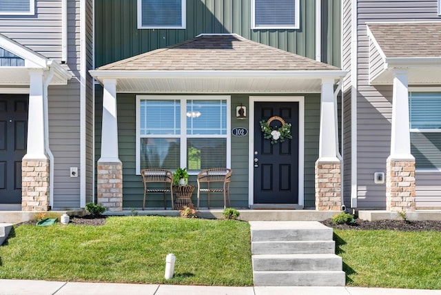 entrance to property with board and batten siding, roof with shingles, and a porch