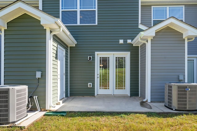 property entrance with a patio area and central AC