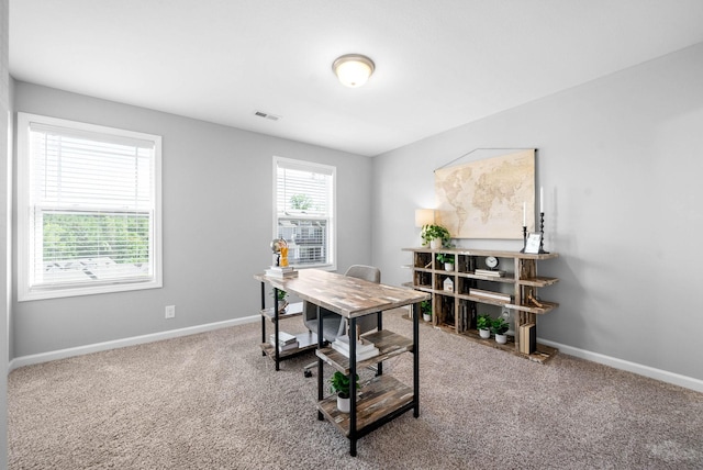 home office featuring carpet floors, baseboards, and visible vents