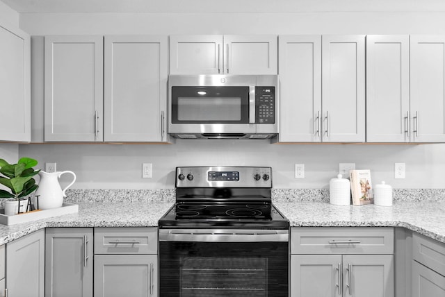 kitchen featuring appliances with stainless steel finishes and light stone countertops