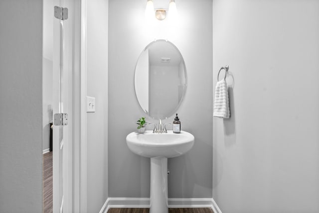 bathroom featuring baseboards and wood finished floors