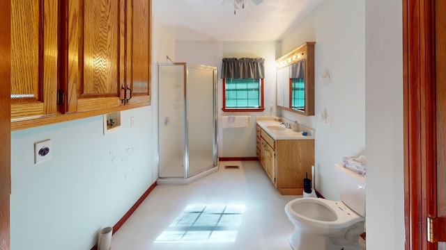 bathroom featuring vanity, toilet, and walk in shower