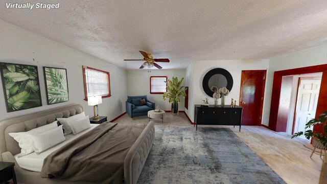 bedroom with ceiling fan and a textured ceiling