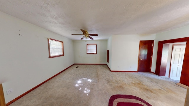 spare room featuring ceiling fan and a textured ceiling