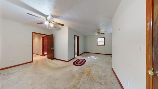 spare room featuring a textured ceiling and ceiling fan