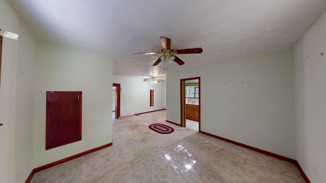 empty room with a textured ceiling and ceiling fan