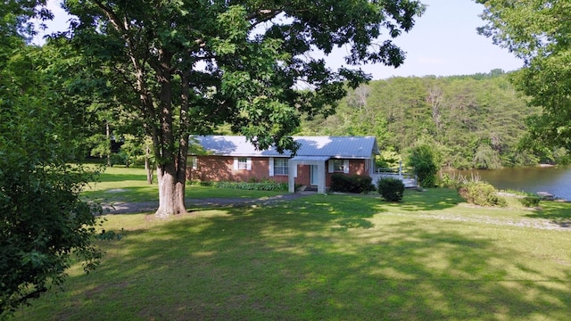 115 Lake Shore Dr, Pikeville, TN 37367 - single story home featuring a front lawn, a wooded view, a water view, and metal roof