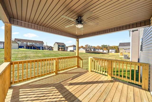 wooden terrace featuring a yard and ceiling fan