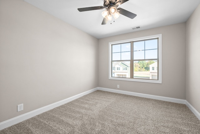 spare room featuring carpet and ceiling fan