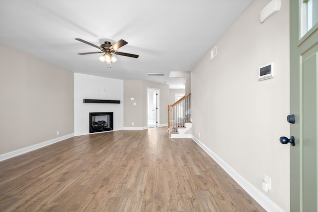 unfurnished living room featuring light hardwood / wood-style flooring and ceiling fan