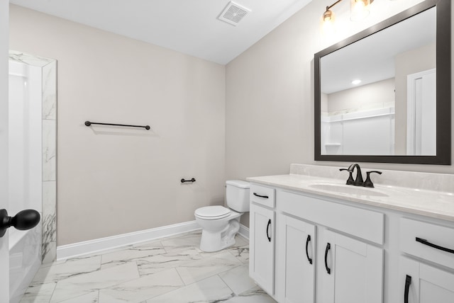 bathroom featuring vanity and toilet