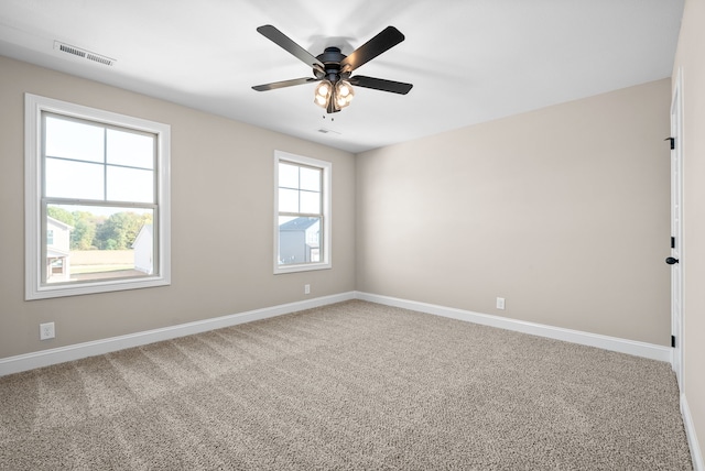 carpeted empty room featuring ceiling fan