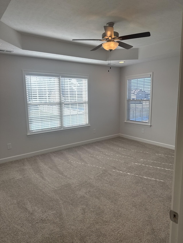 unfurnished room with a healthy amount of sunlight, ceiling fan, and carpet floors