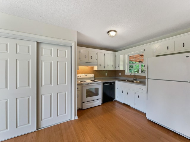 kitchen with light hardwood / wood-style floors, white cabinetry, white appliances, and sink