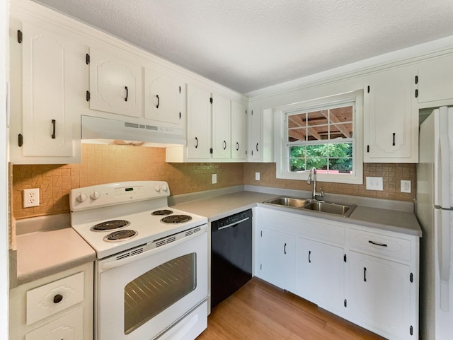 kitchen with white cabinetry, white appliances, sink, and light hardwood / wood-style flooring