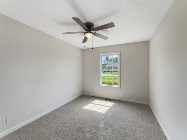 empty room with carpet, a textured ceiling, and ceiling fan