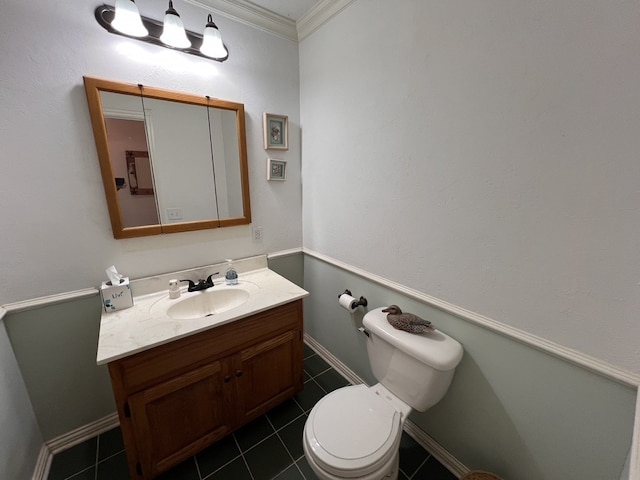 bathroom with tile floors, crown molding, vanity, and toilet