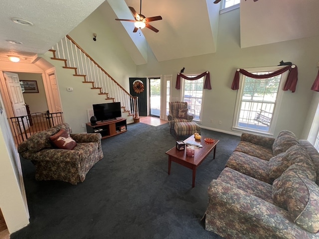 carpeted living room featuring a high ceiling and ceiling fan