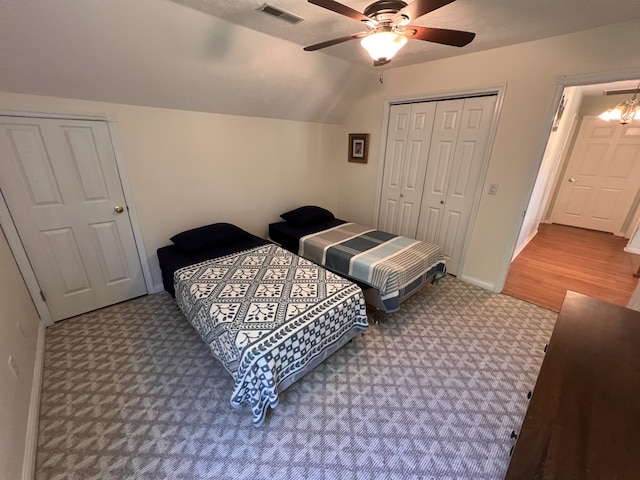 carpeted bedroom featuring a closet, ceiling fan, and lofted ceiling