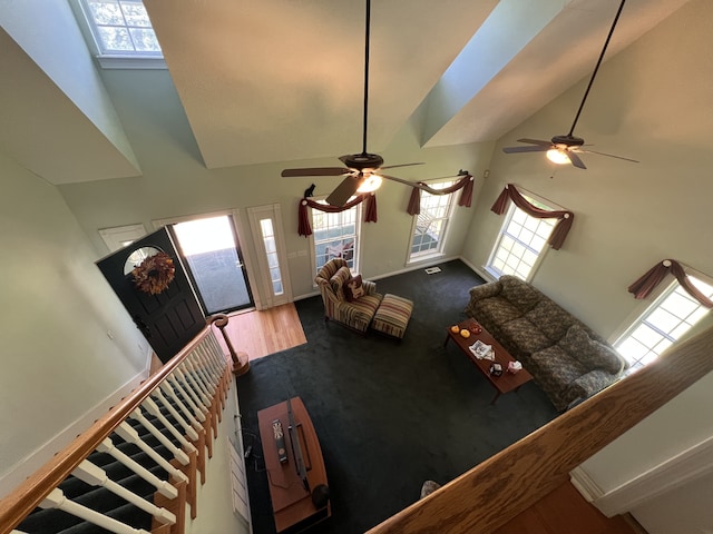 living room featuring high vaulted ceiling, ceiling fan, and wood-type flooring