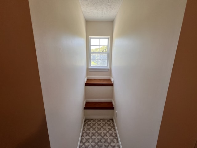 interior space featuring tile flooring and a textured ceiling