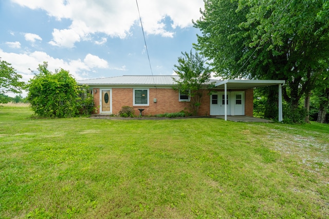 view of front of property with a carport and a front lawn