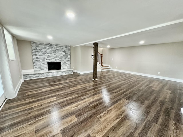 unfurnished living room featuring a fireplace and dark hardwood / wood-style floors