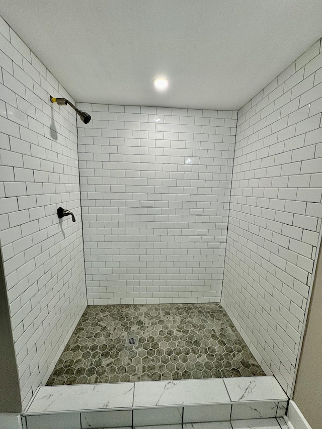 bathroom with a tile shower