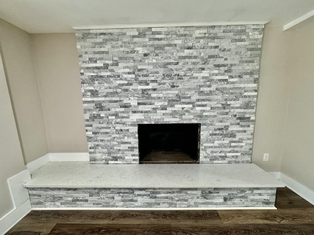 details with hardwood / wood-style flooring and a fireplace