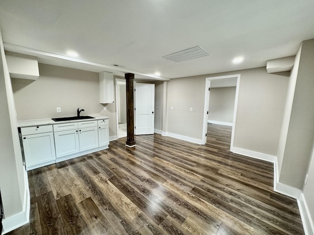 interior space with sink and dark wood-type flooring