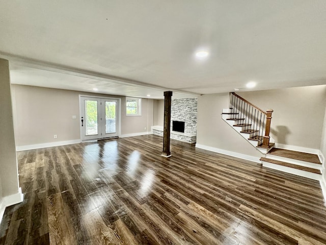 unfurnished living room featuring a fireplace and dark hardwood / wood-style floors