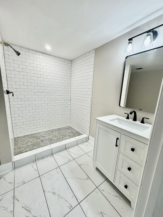 bathroom featuring vanity and a tile shower