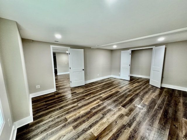 basement with dark hardwood / wood-style flooring