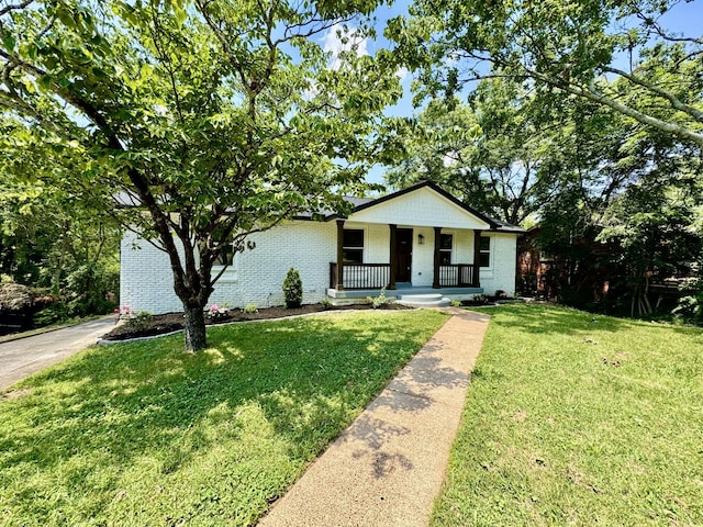 view of front of home with a porch and a front lawn