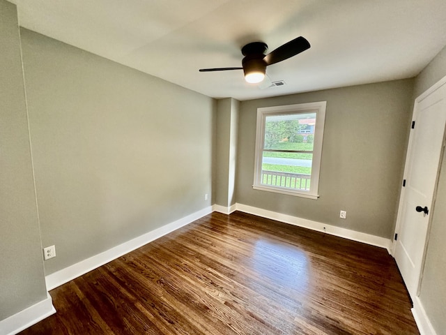 empty room featuring dark hardwood / wood-style floors and ceiling fan