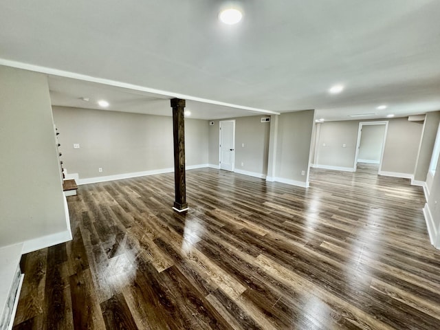 basement with dark hardwood / wood-style floors