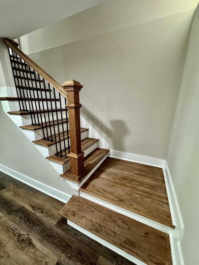 stairway featuring hardwood / wood-style floors