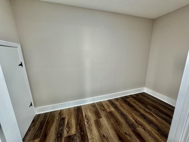 empty room featuring dark hardwood / wood-style flooring