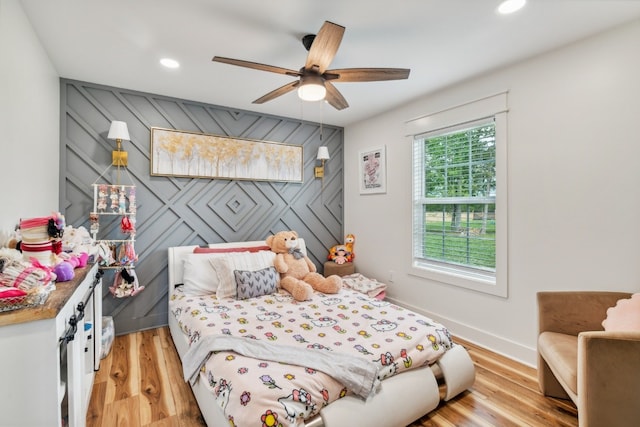 bedroom with light wood-type flooring and ceiling fan