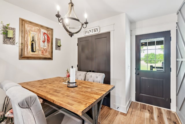 dining space featuring an inviting chandelier and hardwood / wood-style floors