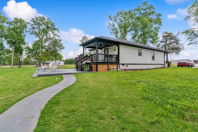 back of property featuring a wooden deck and a yard