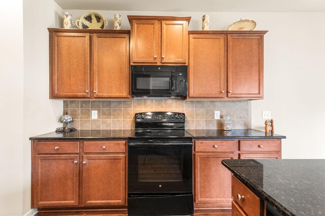 kitchen with backsplash, black appliances, and dark stone countertops