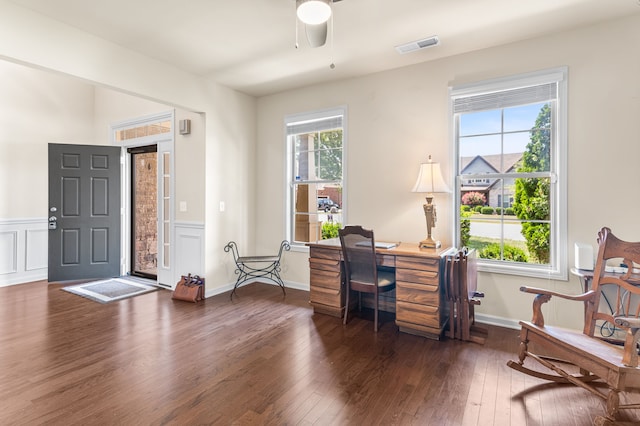 office featuring ceiling fan, dark wood-type flooring, and a healthy amount of sunlight