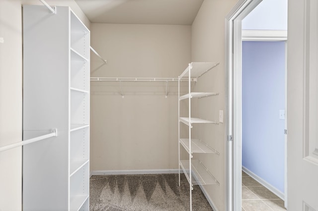 walk in closet with tile patterned flooring